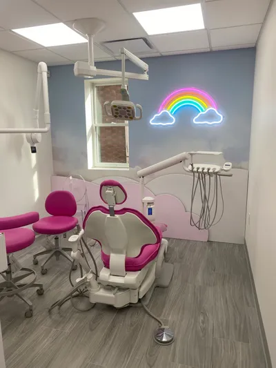 Pediatric dental operatory with a neon rainbow sign